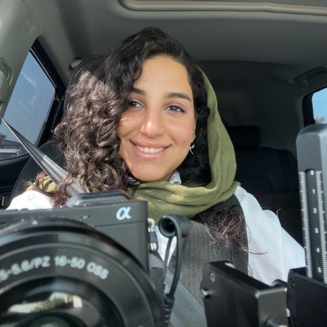 Ayda Mansourieh — photographer holding a camera in her studio